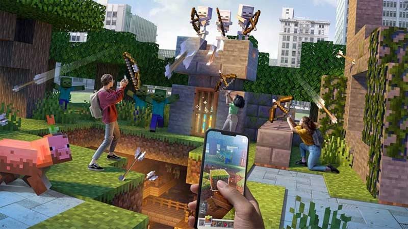 A hand holds a mobile phone with a thumb placed on it at the bottom of an image displaying a vast Minecraft cyberscape, Minecraft blocks spread across with numerous players arrayed across battlements fighting skeletons, shooting arrows, firing spells, fending them off in a grand augmented reality adventure!