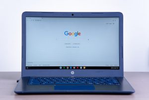 A black HP Chromebook sitting on a table