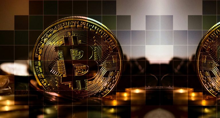 A bitcoin displayed with digital blocks cut into it artistically as a cryptocurrency display