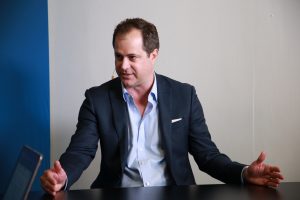 Patrick Palomo, VP of solutions engineering at Smarsh Inc taling to theCUBE about AI in financial communications at AWS Financial Services Symposium 2024