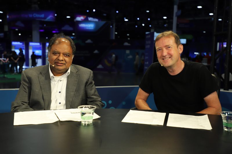 Kumaran Siva (left), corporate vice president of strategic business development at Advanced Micro Devices Inc. and Paul Turner, vice president of products, VMware Cloud Foundation Division, at Broadcom Inc., talk with theCUBE about GPU virtualization – VMware Explore 2025.