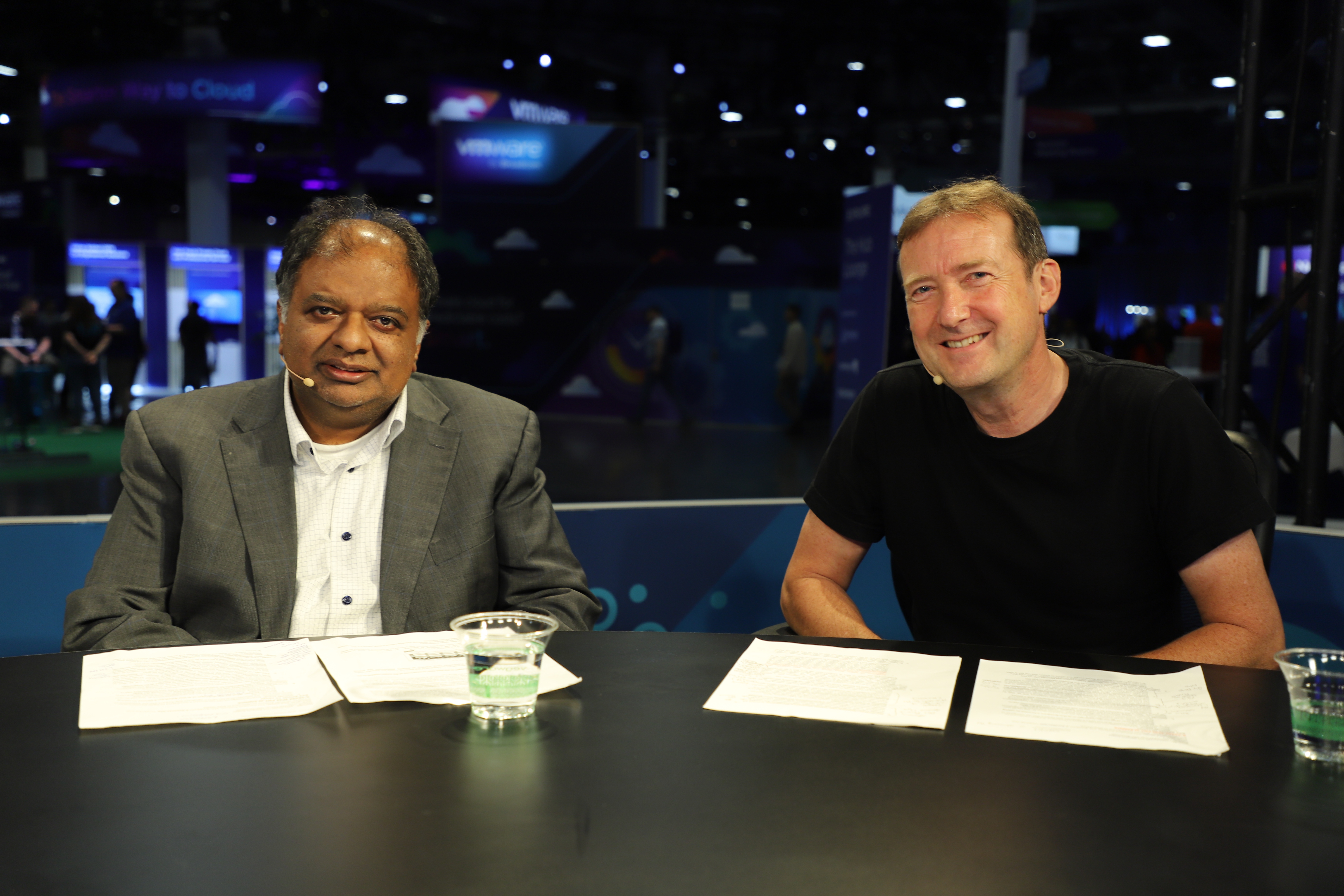 Kumaran Siva (left), corporate vice president of strategic business development at Advanced Micro Devices Inc. and Paul Turner, vice president of products, VMware Cloud Foundation Division, at Broadcom Inc., talk with theCUBE about GPU virtualization – VMware Explore 2025.