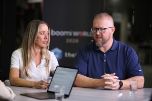 Suzanne McIvor (left), Director of Strategic Business Alliances at RSM, and Justin Tapp (right), Integration Architect at Shearer's Foods, talk to theCUBE about how mid-market AI adoption requires data readiness and governance before deployment, at Boomi World 2026.